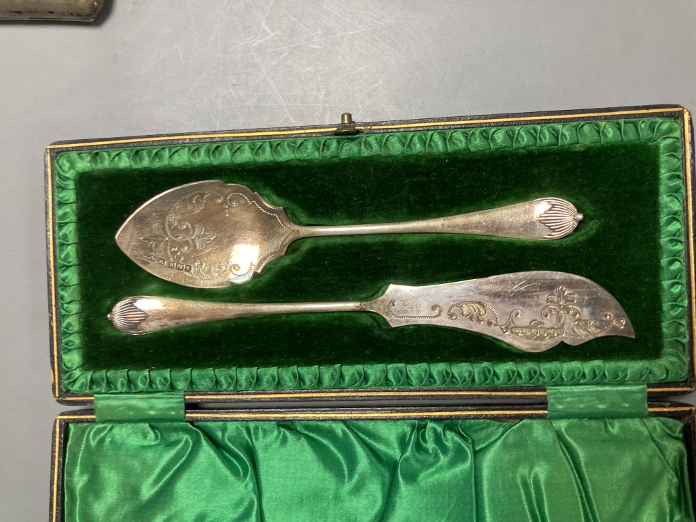 A pair of oval silver salts and spoons (cased), a butter knife and preserve spoon (cased), two pepperettes & a silver cigarette case